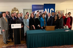 NCCCS President Peter Hans and NCICU President Hope Williams stand with representatives of colleges that signed articulation agreements.